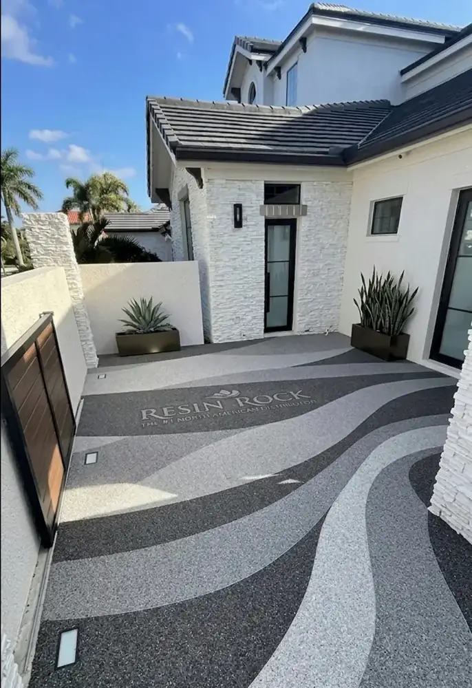 Resin bound entry courtyard with a flowing wave pattern in gray tones